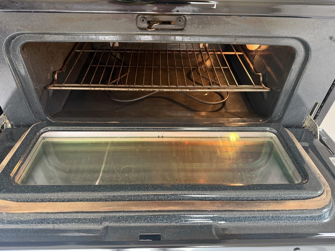 Oven interior — baked-on grime gone — after cleaning