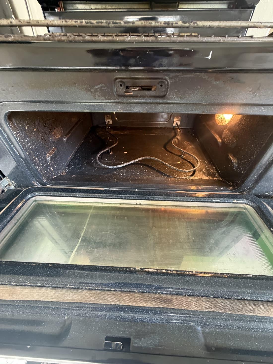 Oven interior — baked-on grime gone — before cleaning